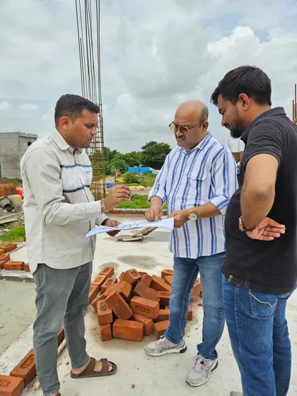 Reviewing the blueprint with the construction team. It is crucial that every detail, from pillar placement to room dimensions, aligns with the energy grid of the property.