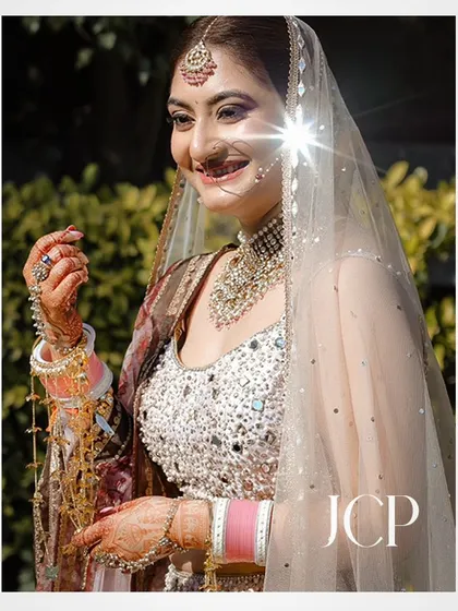 A sun-kissed bridal portrait, with a lens flare adding a touch of magic.
