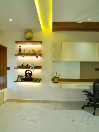 A spacious and luxurious home office with a floating desk, illuminated display shelves, and a cozy window seat for breaks, all designed to fuel productivity.
