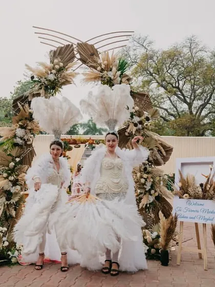 Performers in ethereal white costumes welcome guests, perfectly matching the rustic and dreamy decor.