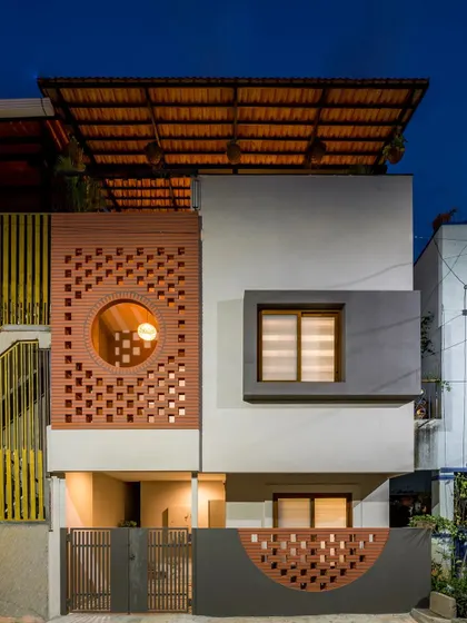 This is the Mathrukrupa residence, a 30-year-old building we completely transformed. The facade features a custom terracotta jali screen that provides both privacy and passive cooling, embodying my approach of integrating natural, local materials with modern architectural forms.