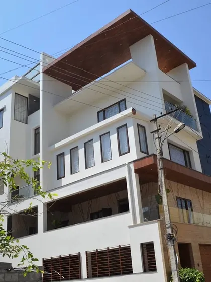 Another exterior view of the integrated HSR Layout project, showing the rear and side elevations. This reveals the complexity of the building's form and the consistent use of materials across all faces.