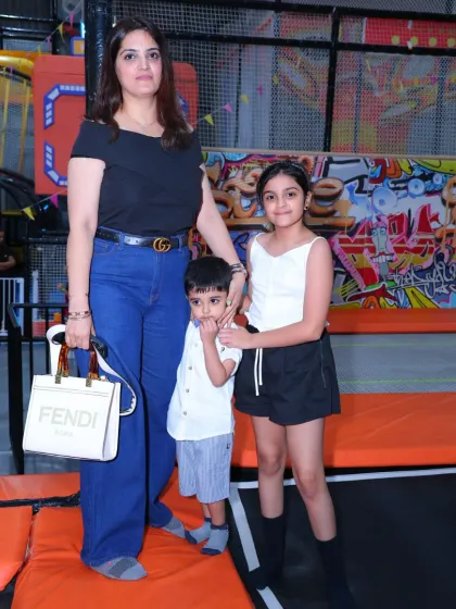 A mother and her two children posing for a photo in our trampoline park. It's a fun experience for the whole family.