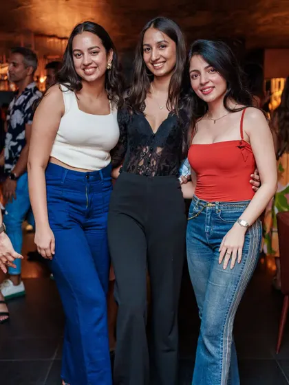 A stylish trio of friends enjoying the upscale atmosphere and music at Kaze.