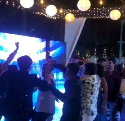 The LED screen adds a modern touch to the outdoor wedding party.