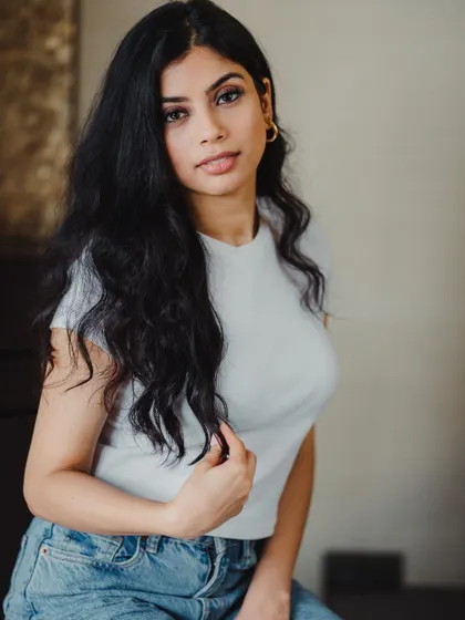 A simple and classic indoor portrait. The soft lighting and the model's direct, gentle expression make this a great headshot for commercial or personal use.