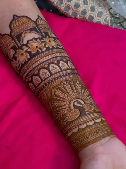 A full forearm design showcasing my skill with architectural and animal motifs. It includes a palace, lotus flowers, and a peacock.