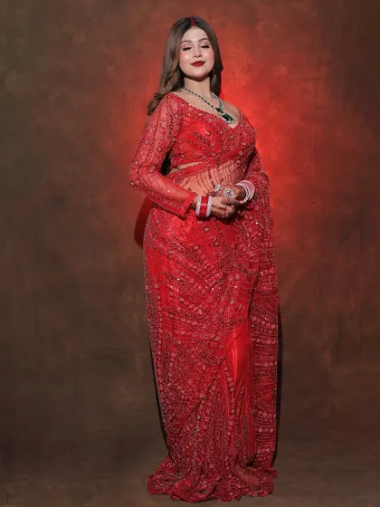 A full-length shot of the red sequined saree, showing its glamorous look.