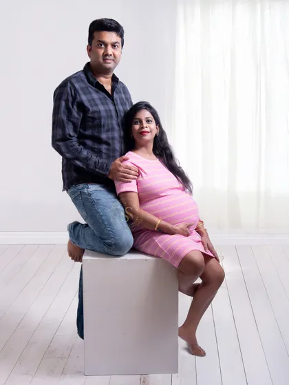 A modern and clean studio portrait. The couple's casual attire against a bright white background gives this shot a fresh and contemporary feel.