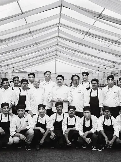 A black and white group photo of me with my culinary team, celebrating International Chef Day.