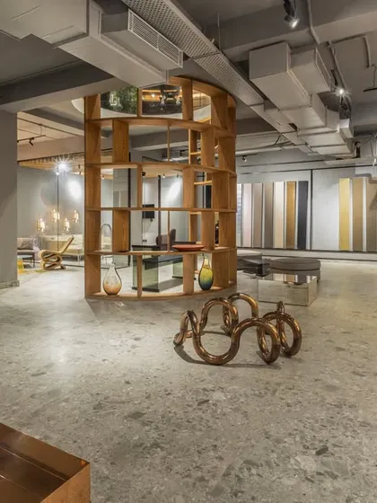Another shot of the SIRCA showroom, highlighting the custom wooden shelving and open, gallery-like layout. The design encourages exploration and interaction with the products.