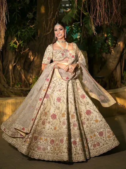 A magical shot with the bride twirling in her lehenga. The lighting creates a beautiful shadow play, highlighting the intricate details of her outfit and her radiant makeup.