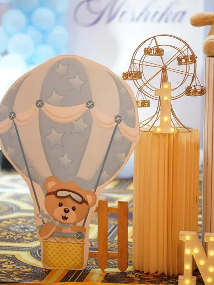A close-up of the hot air balloon prop with a cute teddy bear pilot.