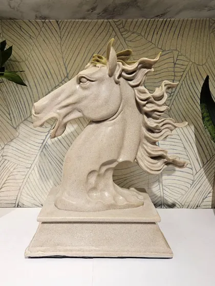 This dynamic horse head sculpture captures the animal in motion. The flowing mane and expressive features make it a captivating piece of art.