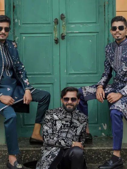 A group of men showcasing a variety of my heavily embroidered indowestern jackets in shades of blue, black, and white.