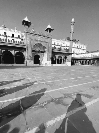The shadows of our tour group stretch across the courtyard of the majestic Jama Masjid. This black and white shot captures a quiet moment of reflection during our walk.