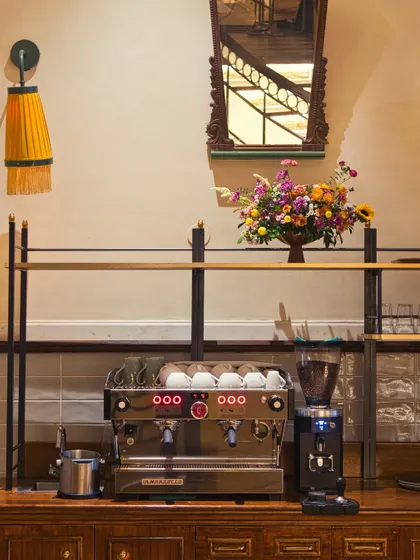 The day begins here, at our coffee station. A state-of-the-art La Marzocco machine, fresh flowers, and elegant decor set the tone for the quality and care we put into every part of your experience, starting with the perfect cup.