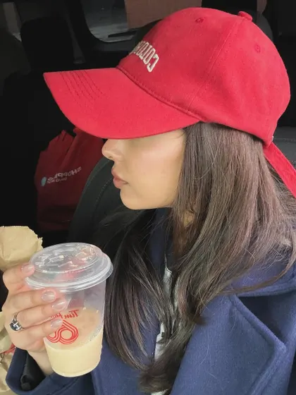 A Pinterest-inspired aesthetic shot with a red cap and a Tim Hortons coffee.