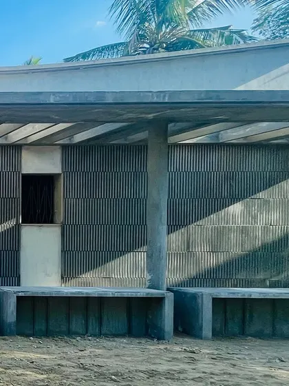 A closer look at the facade of the Palladam residence. The play of light and shadow on the grey fluted panels creates a subtle, elegant rhythm that changes throughout the day.