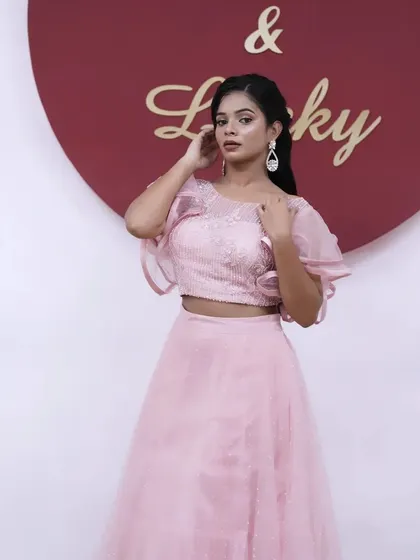 A full-length shot against a branded background, perfect for an event or a brand activation. The look is polished and professional.