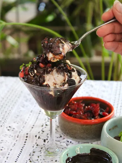 A spoonful of our chocolate sundae, showing the creamy texture of the vegan ice cream mixed with rich brownie and sauce.