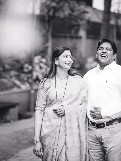A candid black and white photo of a couple walking and laughing together. These unposed moments often make the most cherished memories.