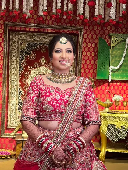 A portrait of the bride against a traditional backdrop, her makeup perfectly complementing the royal setting.