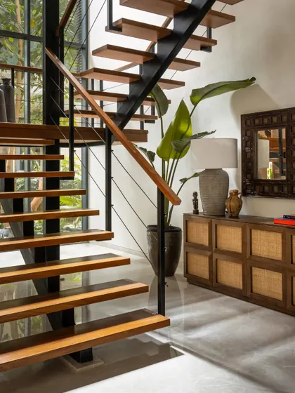 We replaced a solid staircase with this light, open-riser design to improve the flow of light and space. The wood treads and sleek metal supports create a modern architectural feature.