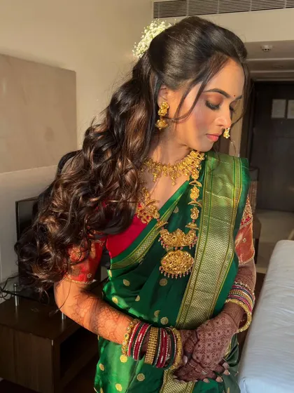 Long, voluminous curls for a Maharashtrian bride. This half updo style is perfect for showing off long hair while still looking traditional and elegant.