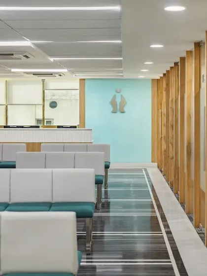 We prioritize user experience by incorporating biophilic design principles. This waiting area is furnished with plush sofas in calming hues, while natural light streams through large windows, creating a soothing atmosphere.