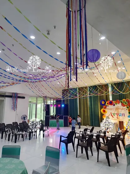 A unique Art & Craft themed party with colorful paper streamers and lanterns decorating the ceiling for a festive, handmade feel.