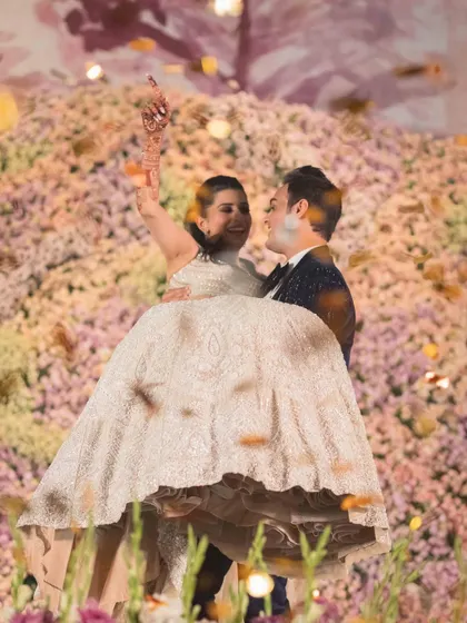 A celebratory lift during a grand finale couple dance. These are the high-energy, picture perfect moments that make your Sangeet unforgettable.