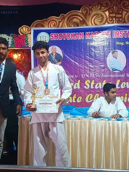 A teen student from our academy with his medal and trophy at the state-level championship. We offer specialized karate training for different age groups, including teens.