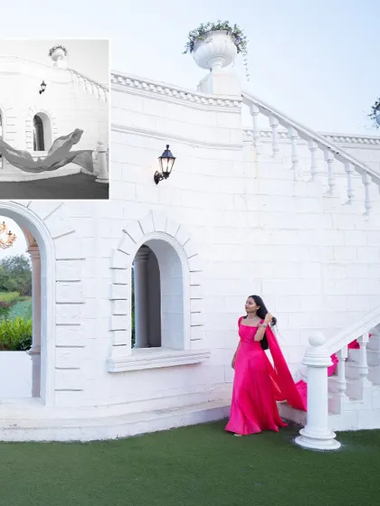 A dramatic pre-wedding photo of the bride-to-be in a flowing pink gown against a striking white building, creating a beautiful color contrast.