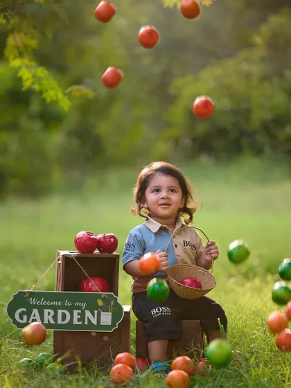 A magical moment in the apple garden. I use creative editing to make it look like apples are raining down, adding a touch of fantasy and fun to this themed toddler shoot.