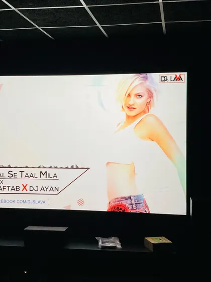 The crisp, clear image from the 4K projector makes any content look great. This shows the vibrant display quality even with a bright music video playing.