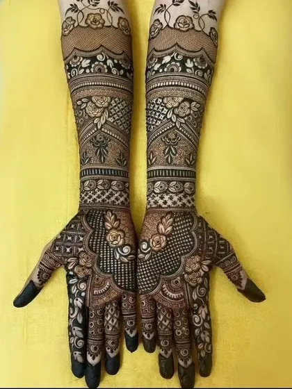 A beautiful floral mehendi design. This pattern uses roses and leaves to create a flowing, elegant look that covers the hands and arms.