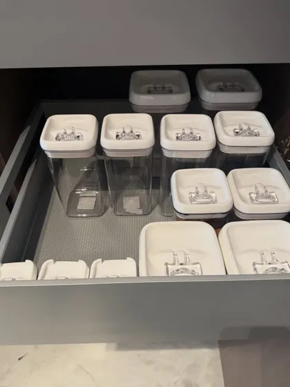 This drawer is for airtight pantry containers. We organize them by size and shape, ensuring the drawer closes smoothly and you can always find the container you need.