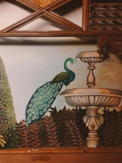 A close-up of the Mughal-style mural for a fine-dining restaurant, featuring a majestic peacock by a fountain. I love bringing such regal and vintage elegance to commercial spaces.