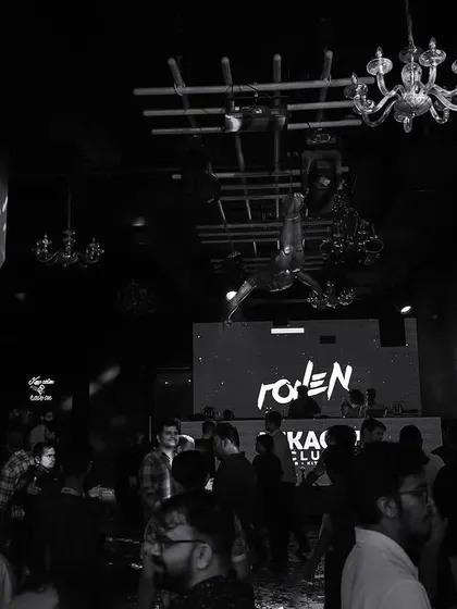 A wide black and white shot of the interior of Mikachi Club.