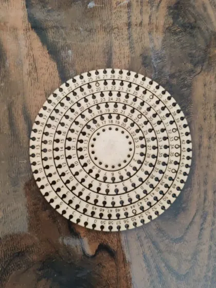 This circular wooden piece is a base for a string art kit, precisely cut and marked by our laser cutter. The machine's accuracy is essential for projects that require exact measurements and spacing.