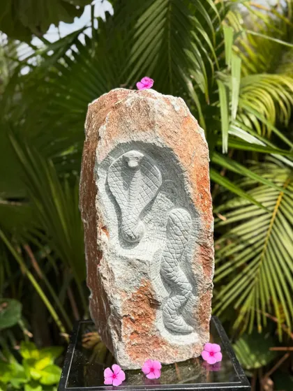 A natural rock carving of Naga Deva, the serpent deity. These intricate sculptures are inspired by the rich cultural and spiritual heritage of South Indian temples, perfect for adding artistry to your garden.