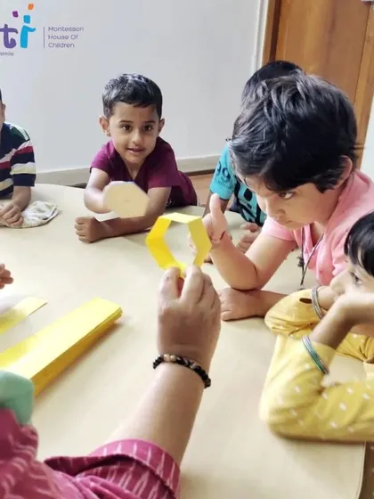 Children gather around their teacher to learn about bees. This lesson on the lifecycle and importance of pollinators is part of our nature and science curriculum.