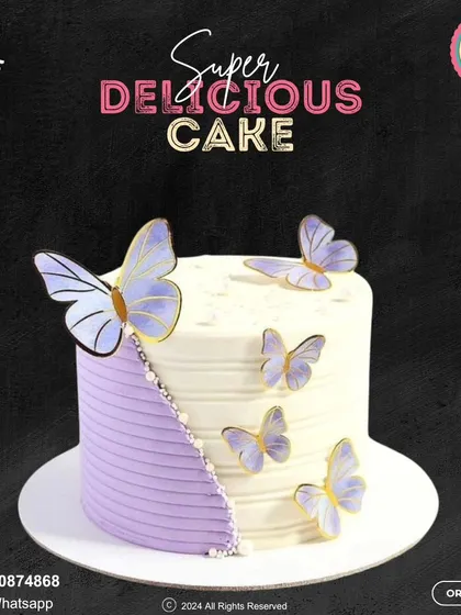 An elegant butterfly-themed cake. This design features a beautiful contrast between a textured purple section and smooth white buttercream, adorned with delicate purple butterflies.