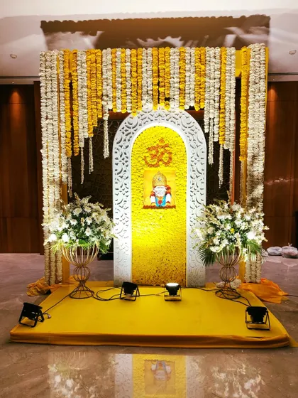 For this Sai Sandhya, I designed a divine backdrop featuring an arch filled with yellow marigolds, a central image of Sai Baba, and the Om symbol, creating a serene space for devotion.