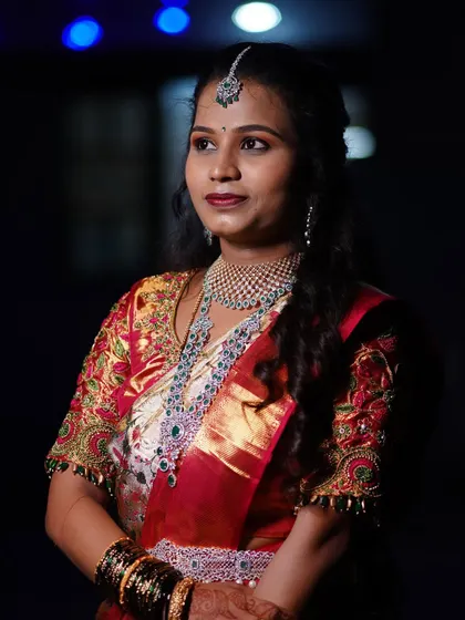 A happy client looking beautiful in her CZ jewellery. The layered necklace and matching maang tikka are perfect for her reception look.