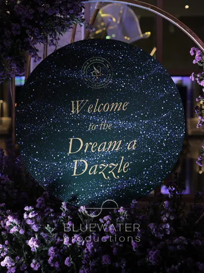 A close-up of the welcome sign for the 'Dream a Dazzle' Sangeet, featuring a glittering, starry background that perfectly introduces the celestial theme.