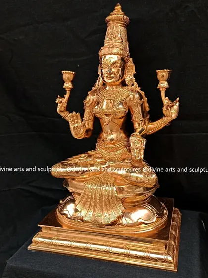 A three-quarter view of the polished Lakshmi, showing the fine details of her attire and the lotus flowers she holds, which symbolize purity and spiritual realization.