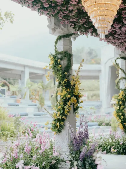 A detail shot of the floral work for Nithya and Payton's wedding. We wrapped the stone pillars with fresh greenery and climbing yellow orchids, bringing the feeling of a wild, blooming garden into the ceremony space.