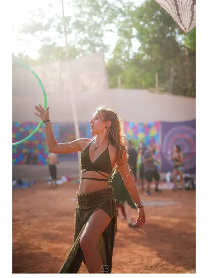 The golden hour at a festival. This beautiful back-lit shot of a hula-hooper captures the magic of the setting sun and the flow of the moment.